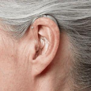 BTE hearing aid in a woman's ear